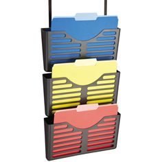 three different colored folders are stacked on top of each other in a metal holder