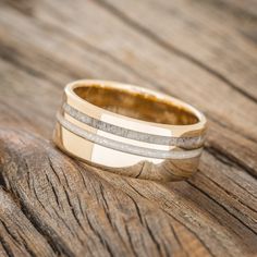 a wedding ring sitting on top of a wooden table