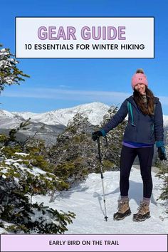 a woman standing on top of a snow covered slope wearing skis and holding ski poles