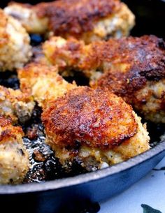 chicken drumsticks cooking in a skillet with the words oven fried panko crusted chicken drumsticks