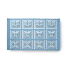 a blue and white placemat with squares on the front, in different sizes and colors