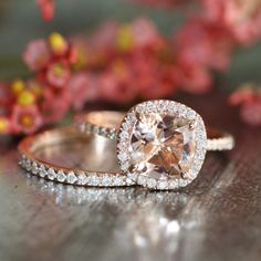 two engagement rings with an oval cut diamond in the center and pave diamonds around them