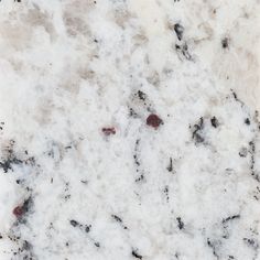 the marble is white and black with brown spots on it's surface, as well as small red dots