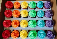 cupcakes with rainbow frosting arranged in rows