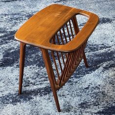 a wooden chair sitting on top of a blue carpet