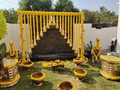 a decorated lawn area with yellow flowers on the grass and decorations hanging from the ceiling