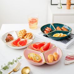 plates and bowls filled with food on top of a table