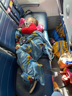 a baby sleeping in the back seat of a car