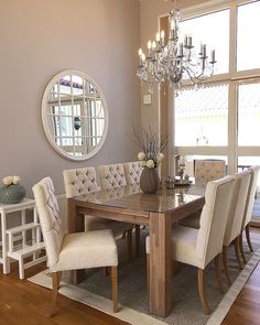 a dining room table with chairs and a chandelier