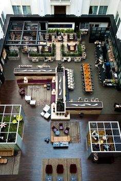 an overhead view of a large building with many tables and couches in the center