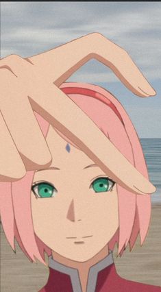 an anime character with pink hair and green eyes, standing in front of the ocean