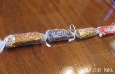 four bags of snacks are lined up on the table