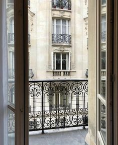 an open balcony with wrought iron railings and balconies on the building's side