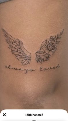 a woman's stomach with two wings and roses on it, the words always love are