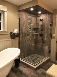 a bathroom with a tub, sink and shower