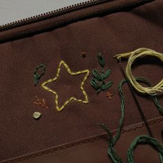 a star is on the side of a piece of cloth with some thread and scissors