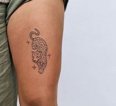 a person with a tattoo on their leg that has a cat and stars on it