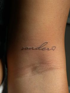 a woman's stomach with the word wander written in cursive writing on it