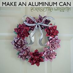 a pink and purple wreath hanging on a door with the words make an aluminum can poinsettia wreath