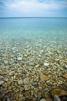 the water is crystal clear and blue with rocks in it's foregrounds