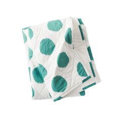 three green and white polka dot napkins on top of each other, one folded in half