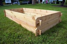 two wooden boxes sitting in the grass