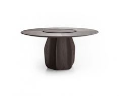 the table is made out of wood and has a circular top with an oval base