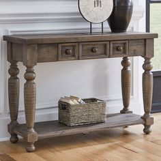 a wooden table with two drawers and a clock on it's side stand in front of a window