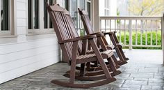 two rocking chairs sitting on the front porch