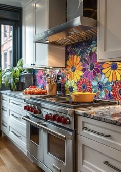 a kitchen with an oven, stove and flowers painted on the backsplash wall