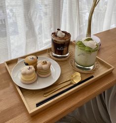 a tray that has some food on it and a drink in the glass next to it