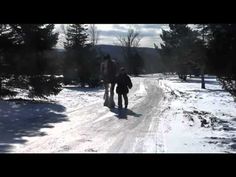 two people walking down a snow covered road