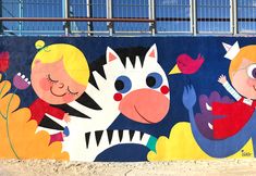 a colorful mural on the side of a building with children and animals painted on it