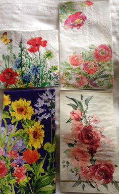 four napkins with flowers and butterflies on them