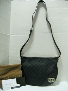 Authentic High End Designer Clothes, Handbags, Shoes, Accessories and Jewelry at Affordable Prices! Always, 100% Authentic Guarantee or 110% Money Back! Since 2001 Fast Shipping-30 Day Hassle Free Returns   New With Tags and Dust Bag Gucci Black GG Motif Logo Canvas with Black Leather Trim Half-Moon Crossbody Bag With Silvertone/Light Goldtone GG Hardware and Zip Top Closure  MADE IN ITALY Approx.  11.5"(Top) W x 9" W x 2" D Adjustable Shoulder Strap: 19" -21" Drop  This gorgeous, iconic Gucci s Bag Gucci, Gucci Models, Silver Logo, Classic Bags, Gucci Black, Leather Silver, Black Canvas, Medium Bags, Canvas Leather