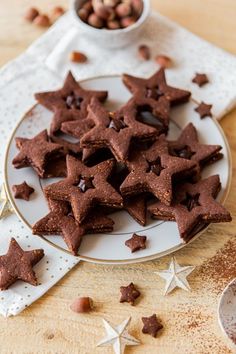 star shaped cookies on a plate with nuts