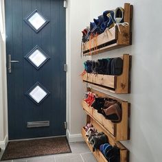 there is a blue door and some shoes on the shelves in front of the door