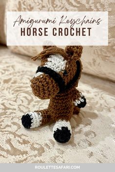 a small crocheted horse sitting on top of a bed