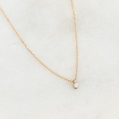 A classic round diamond pendant on a dainty 14k gold chain. This versatile necklace has a place in any woman’s wardrobe, and can make a wonderful gift for a special woman in your life. 1 round lab grown diamond with a width of 1.7mm 0.019 total carat weight Bezel setting Necklace has an adjustable length and can be worn at 16", 17" and 18" Round Diamond Pendant, Mother Jewelry, London Blue Topaz Ring, Stacked Jewelry, Solid Gold Jewelry, Pearl Gemstone, Traditional Jewelry, Diamond Pendant Necklace, Blue Topaz Ring