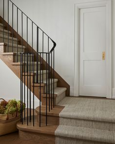 there is a basket on the floor next to some stairs