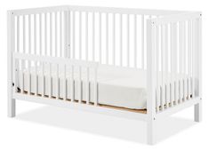 a white crib with a mattress on the bottom and no sheets in front of it