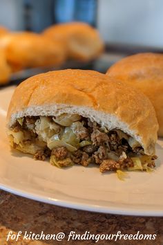 a close up of a sandwich on a plate with other food items in the background