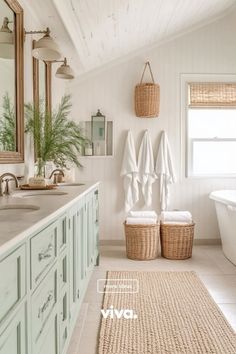 a white bathroom with two towels hanging on the wall and a bathtub next to it