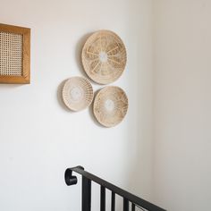 three baskets hanging on the wall above a crib