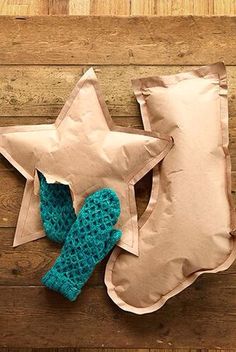 a stuffed star sitting on top of a pillow next to a pair of mittens