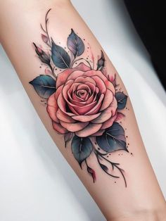 a rose tattoo on the arm with leaves and flowers around it's center piece