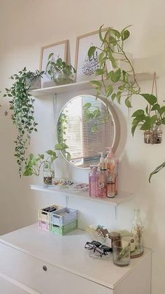 a white dresser topped with lots of plants