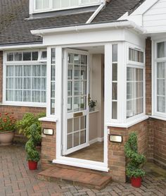 a brick house with white trim and windows