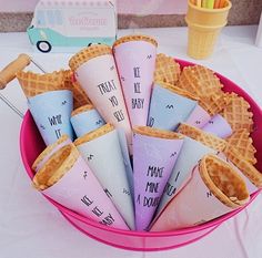 some waffle cones are in a pink bowl