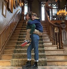 two people are hugging on the stairs